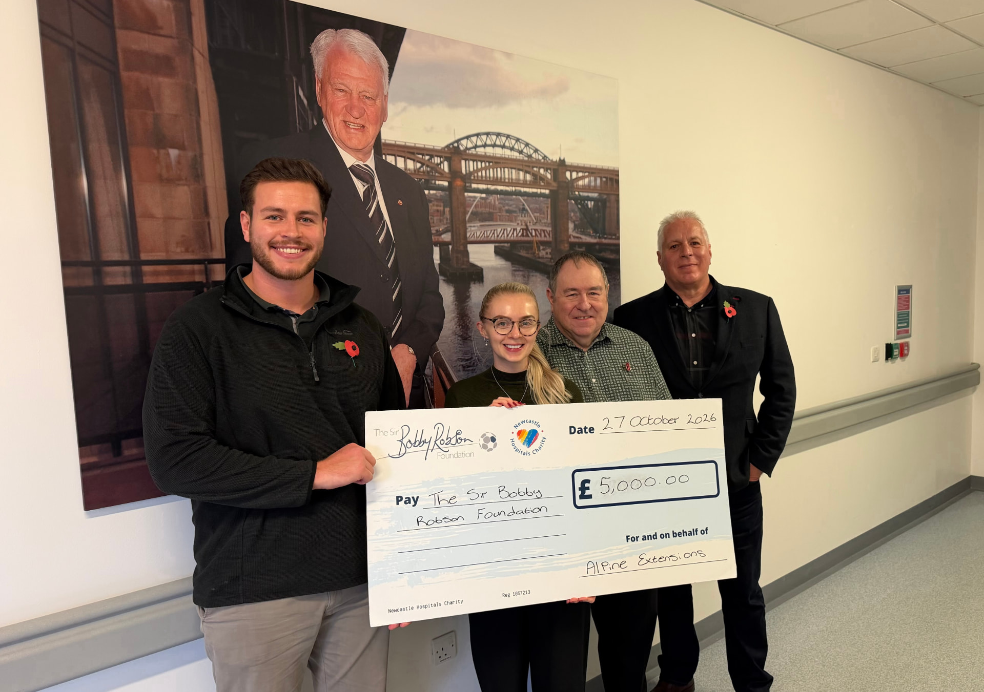The Alpine Extensions team presenting a £5,000 donation cheque to the Sir Bobby Robson Foundation at the Freeman Hospital in Newcastle