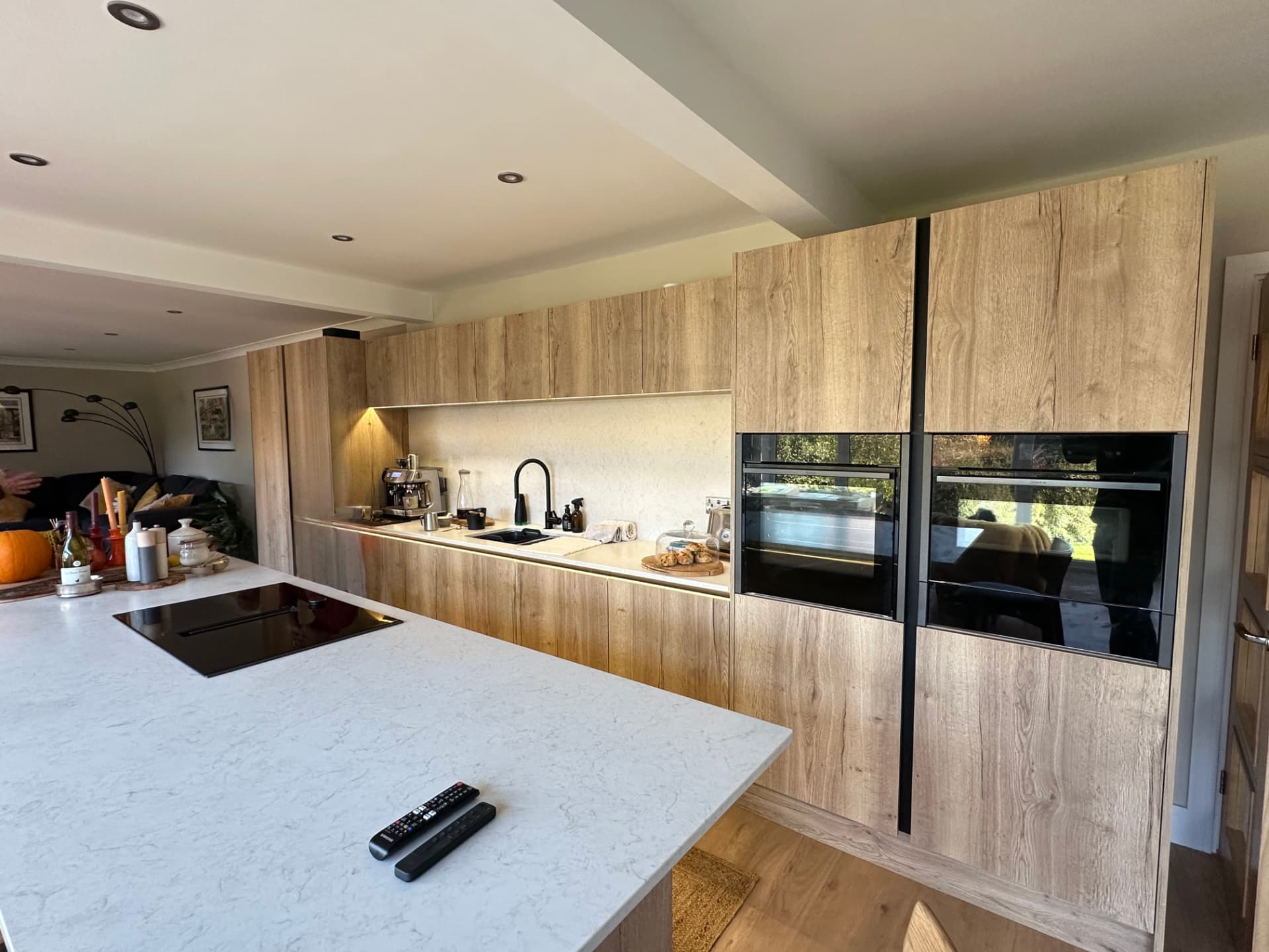 Full-height oak kitchen units with twin ovens
