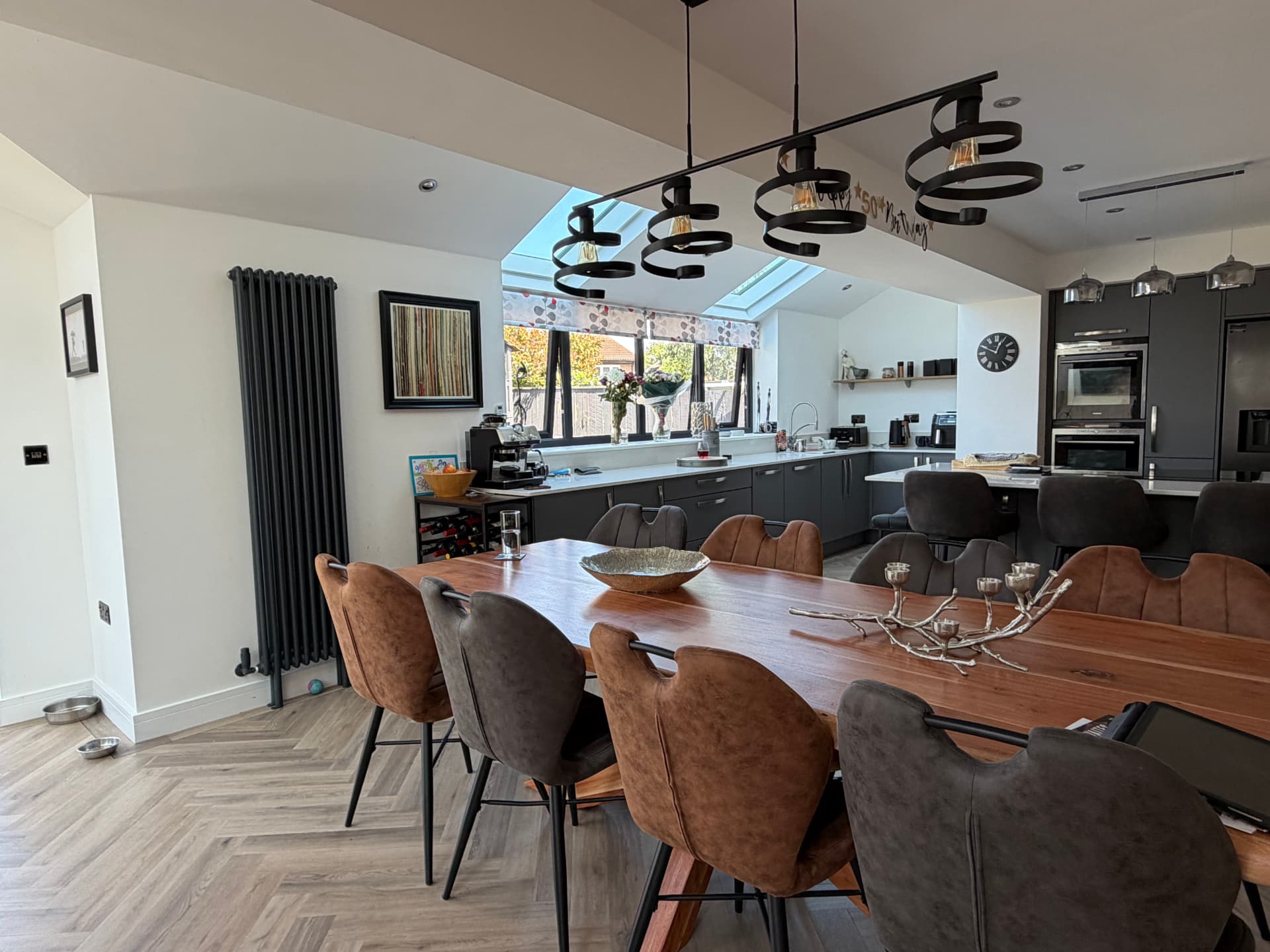 Open-plan dining table looking through to the kitchen