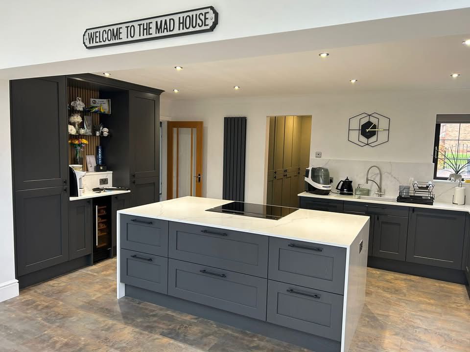 Kitchen island with induction hob and concealed breakfast pantry cabinet