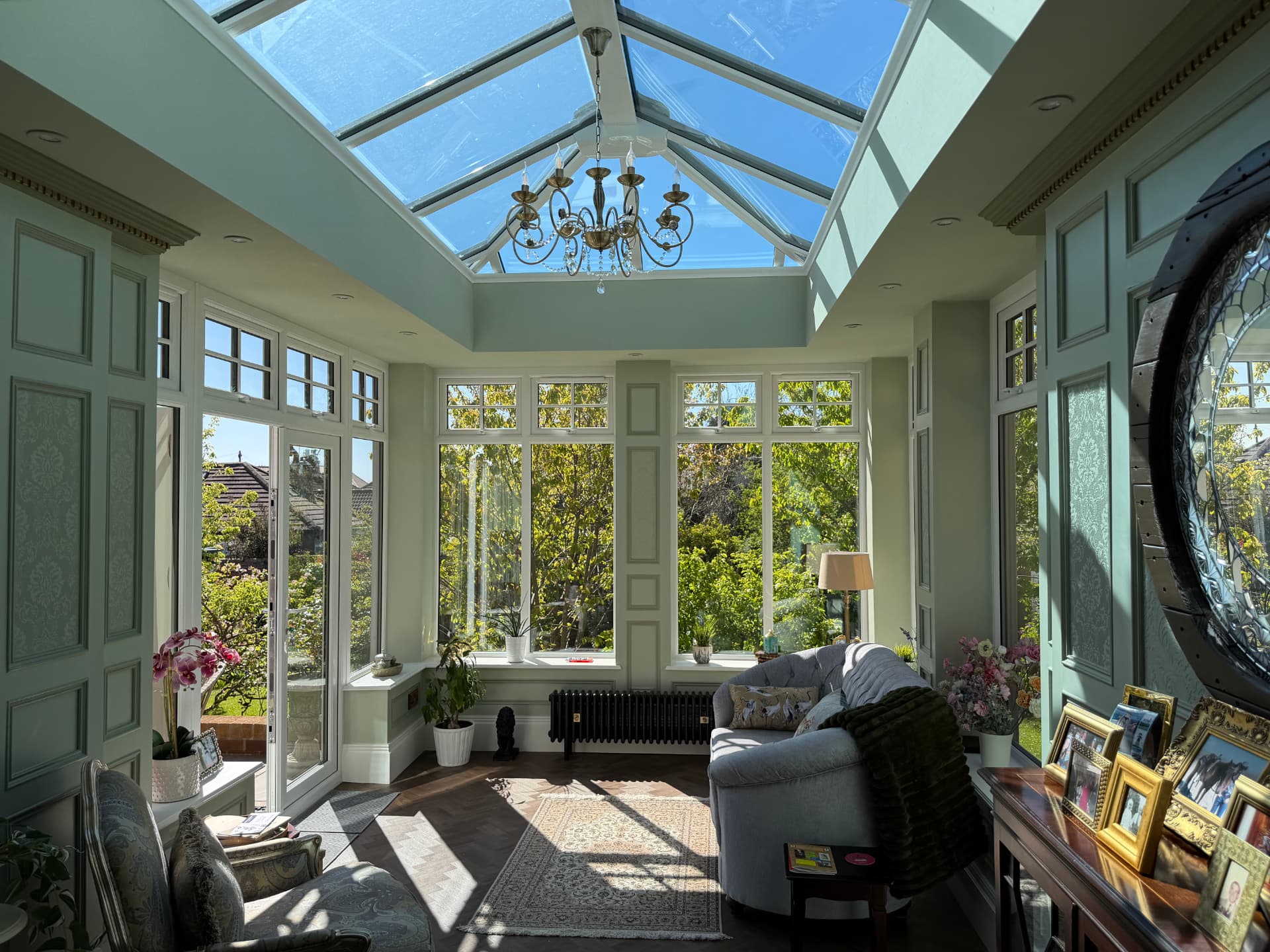 Interior of the orangery with glazed lantern roof and chandelier