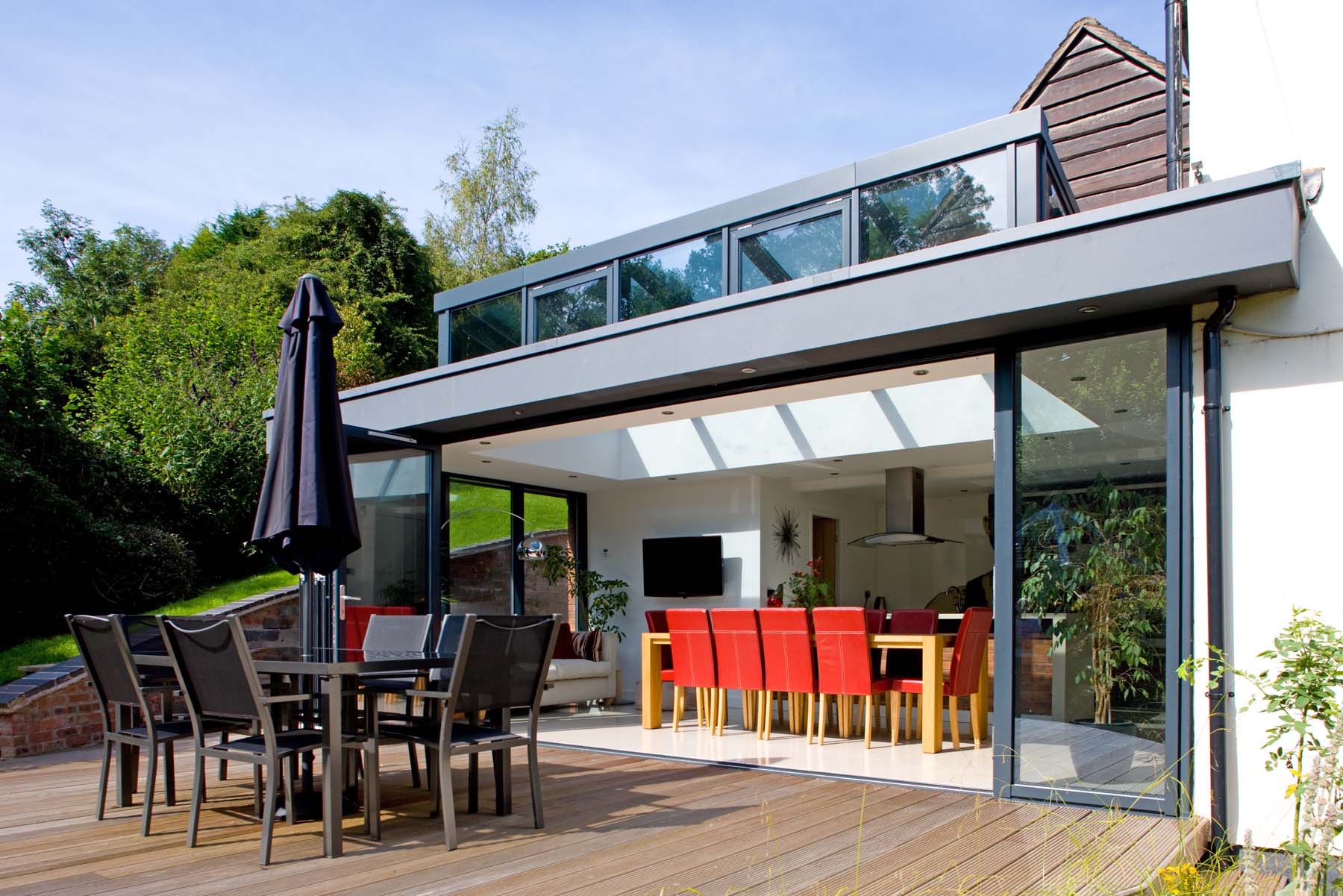 Contemporary kitchen-diner extension in Alnwick with bifold doors and roof lanterns by Alpine Extensions