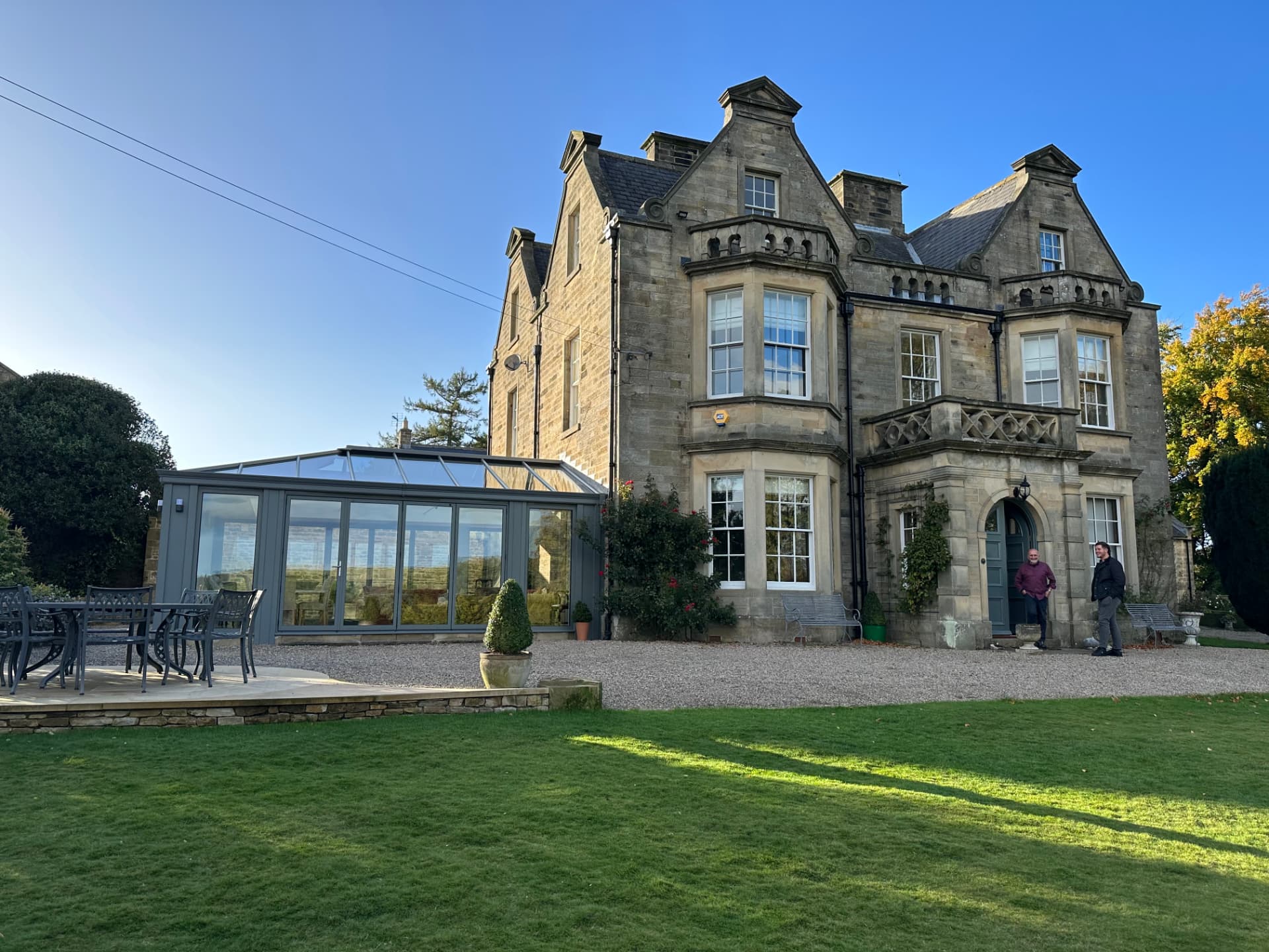 Aluminium orangery with glazed lantern roof attached to a Grade II listed sandstone country house in Romaldkirk