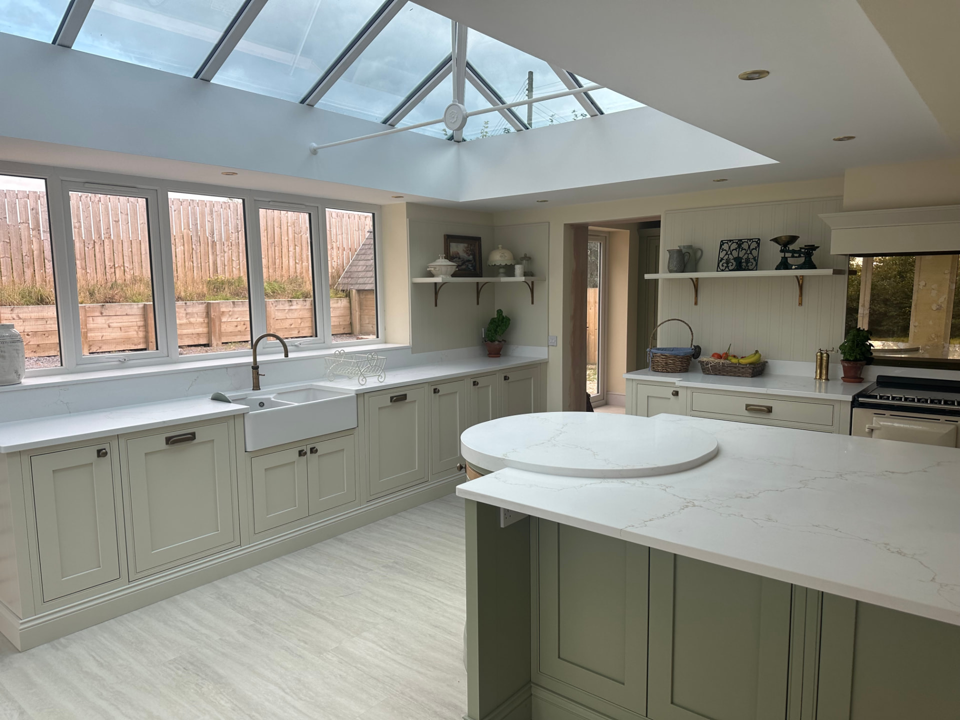 Sage green shaker kitchen extension with glazed lantern roof at The Parks, Muggleswick