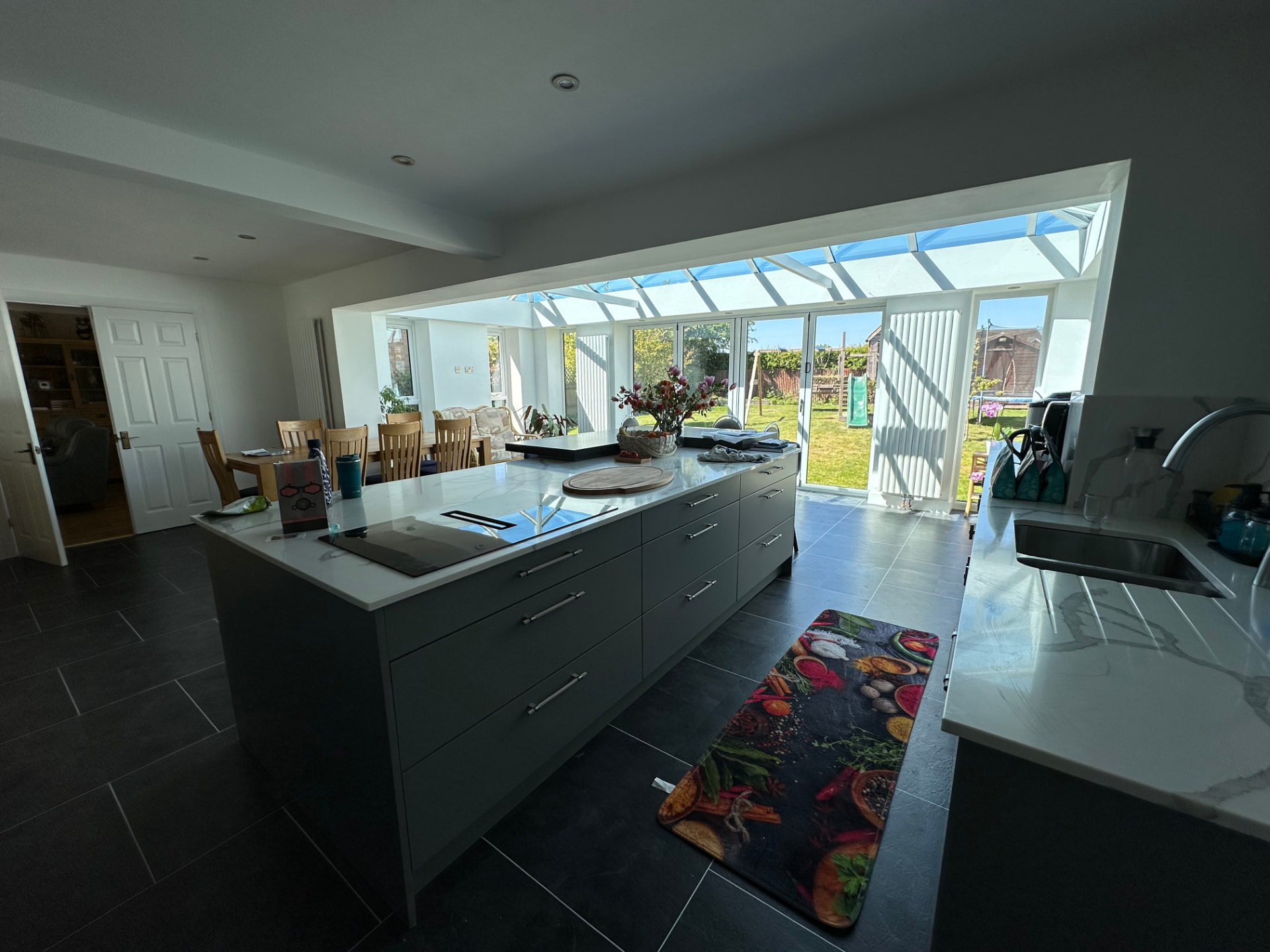 Grey kitchen island beneath the light-filled glazed extension roof