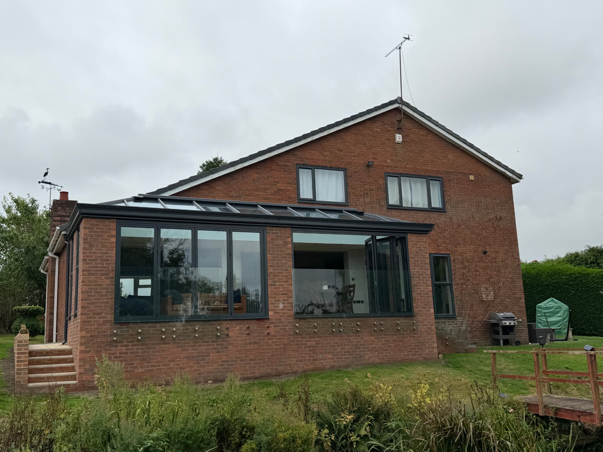 Brick-built kitchen extension with anthracite glazing and lantern roof in Darras Hall, Ponteland