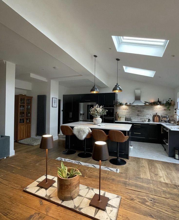 Vaulted open-plan kitchen and living space with breakfast bar seating