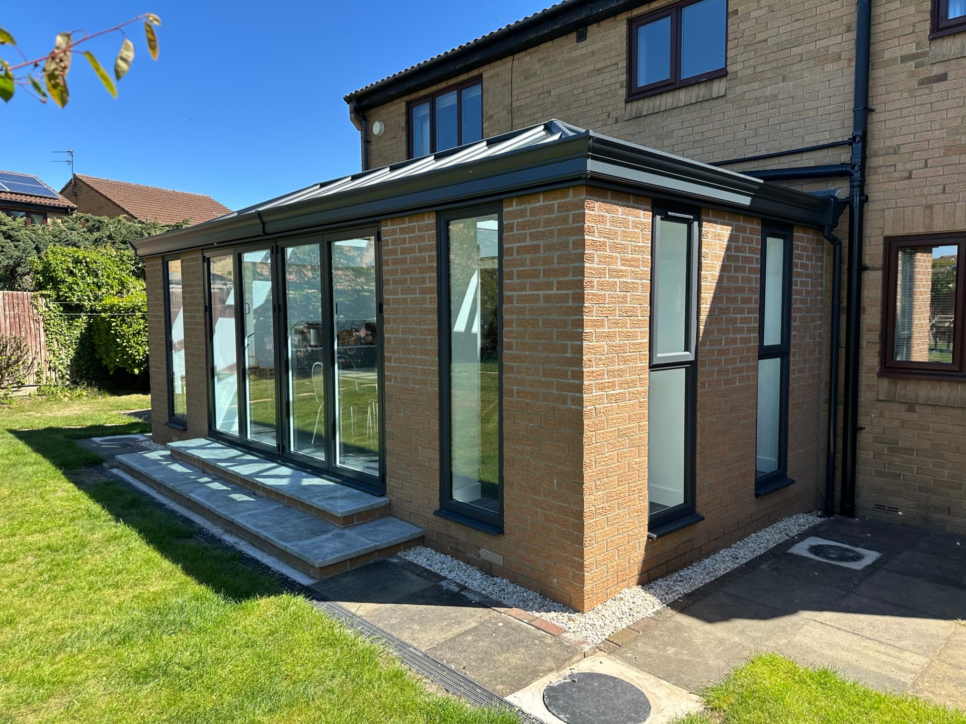 Side exterior view of the brick extension with anthracite frames in Langley Park