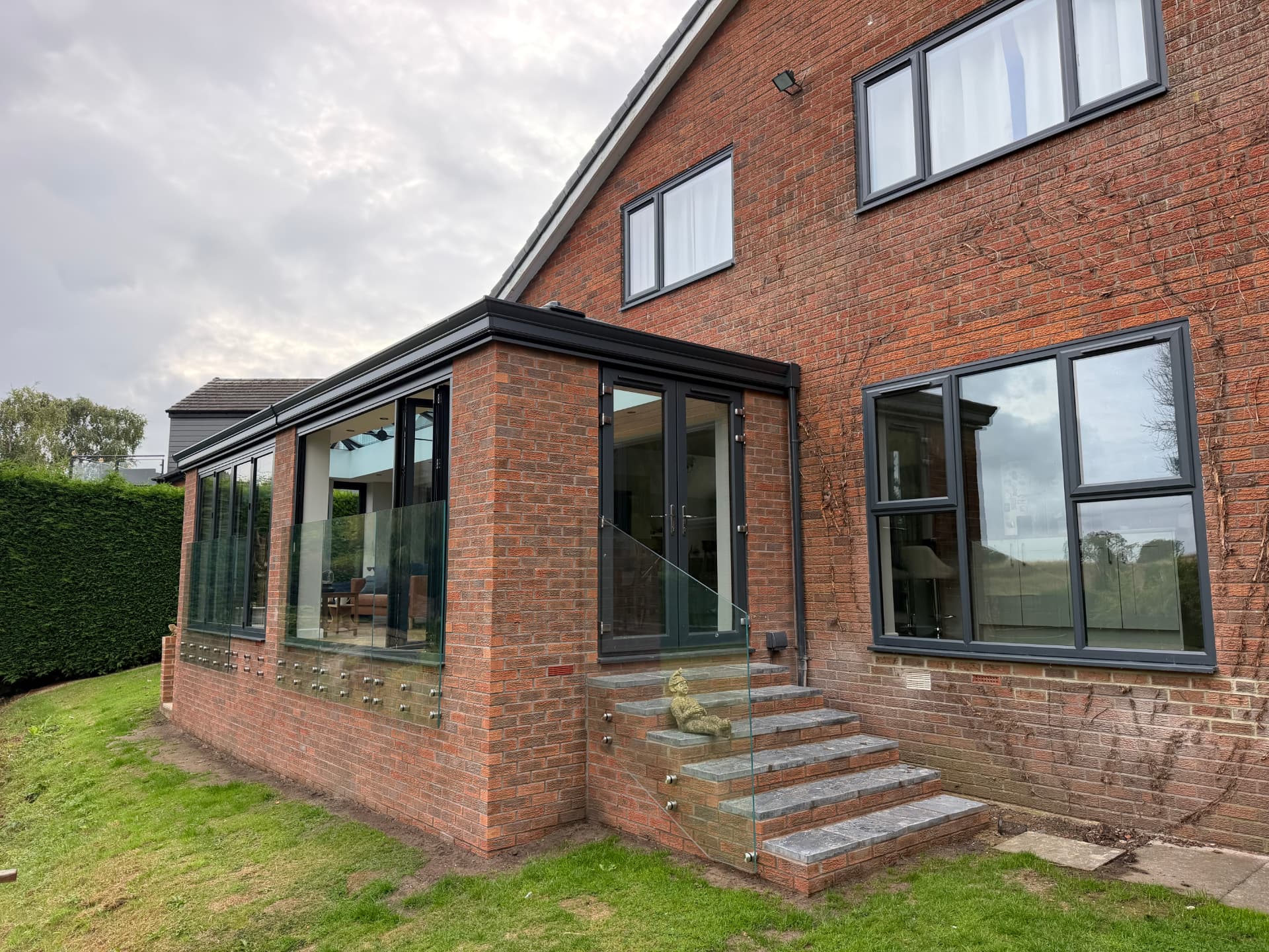 Side view of the Ponteland extension with glass balustrade and granite steps