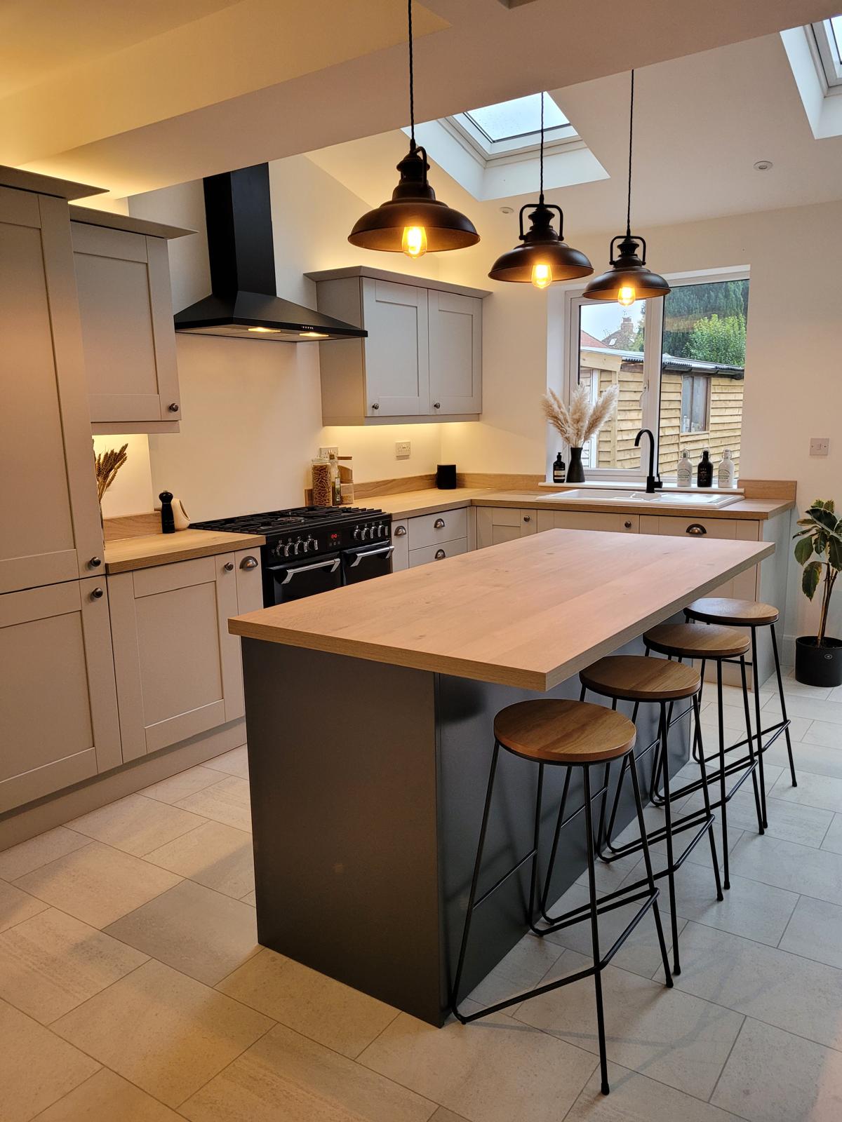 Stone shaker kitchen extension in Morpeth with oak topped graphite island and industrial pendant lighting