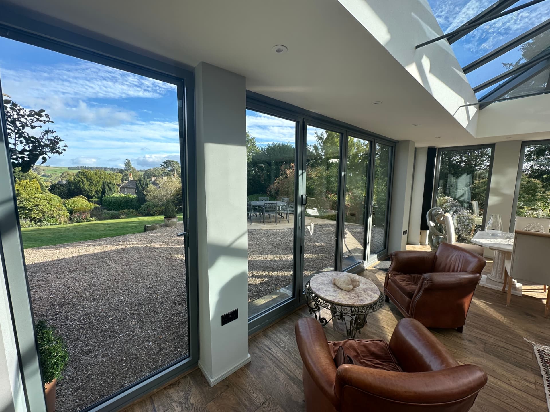 Seating area inside the orangery looking out over the lawn and Teesdale countryside