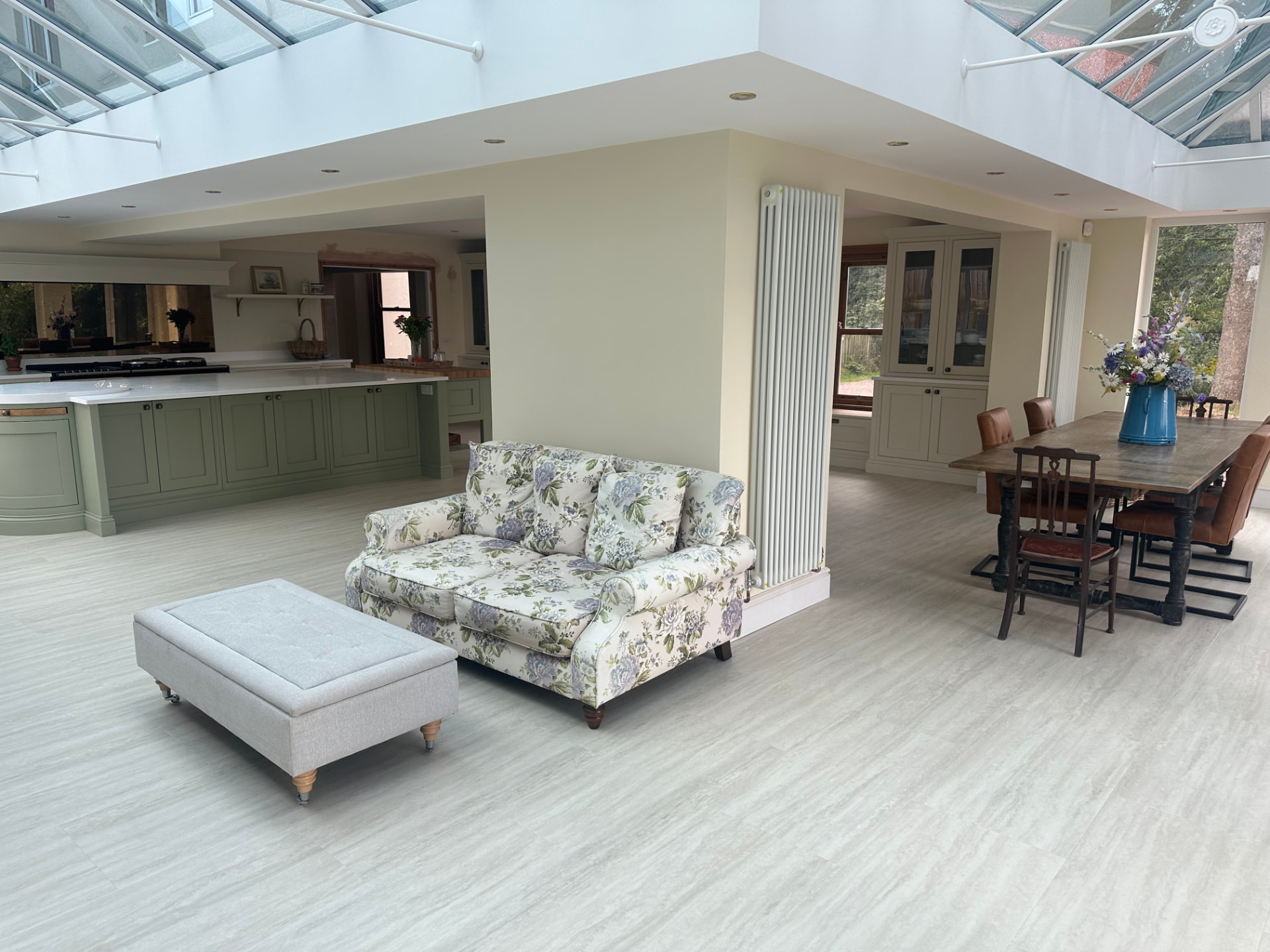 Broad living space linking kitchen and dining areas with twin lantern roofs