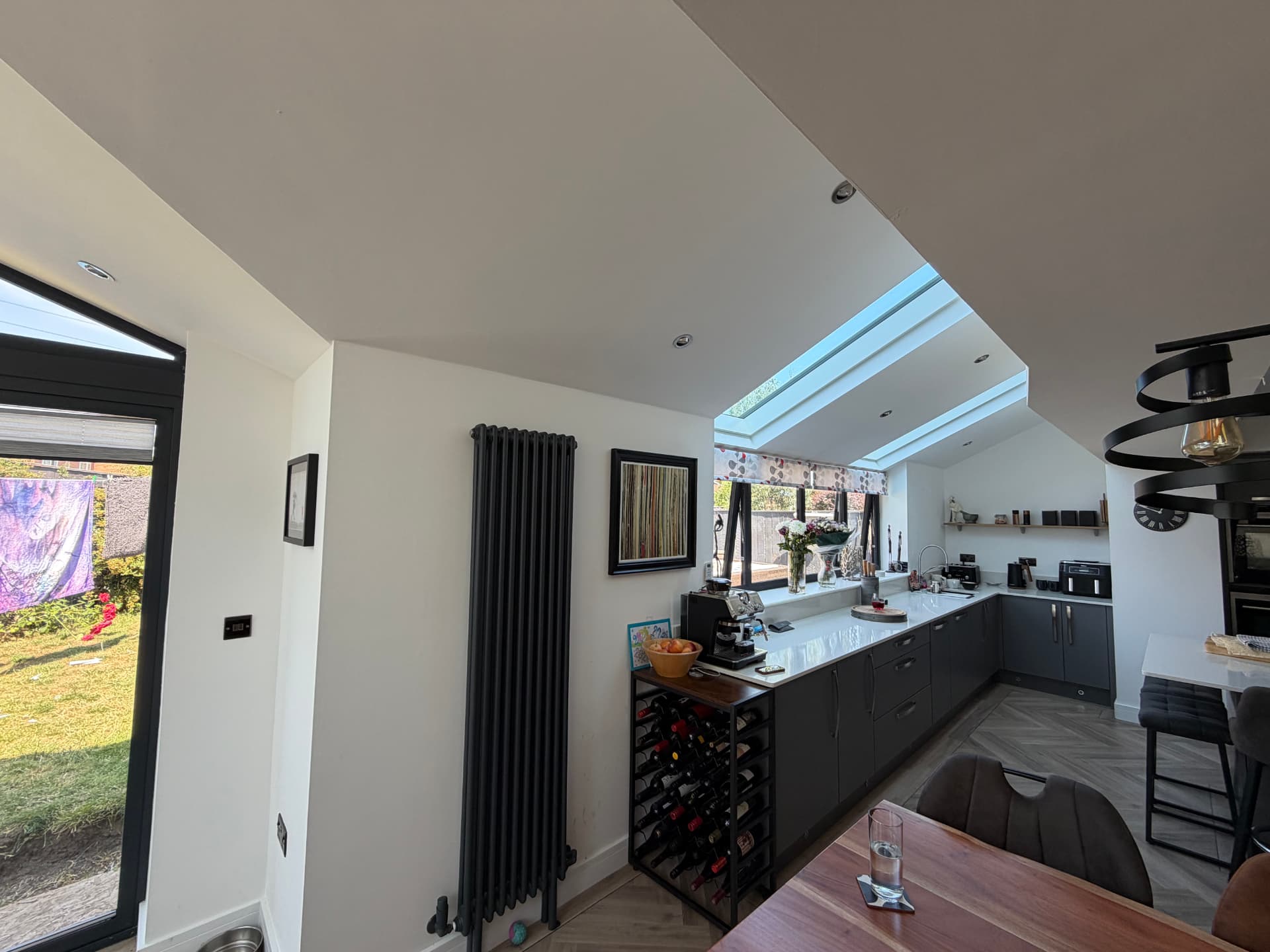 Graphite kitchen with quartz worktops and roof light above