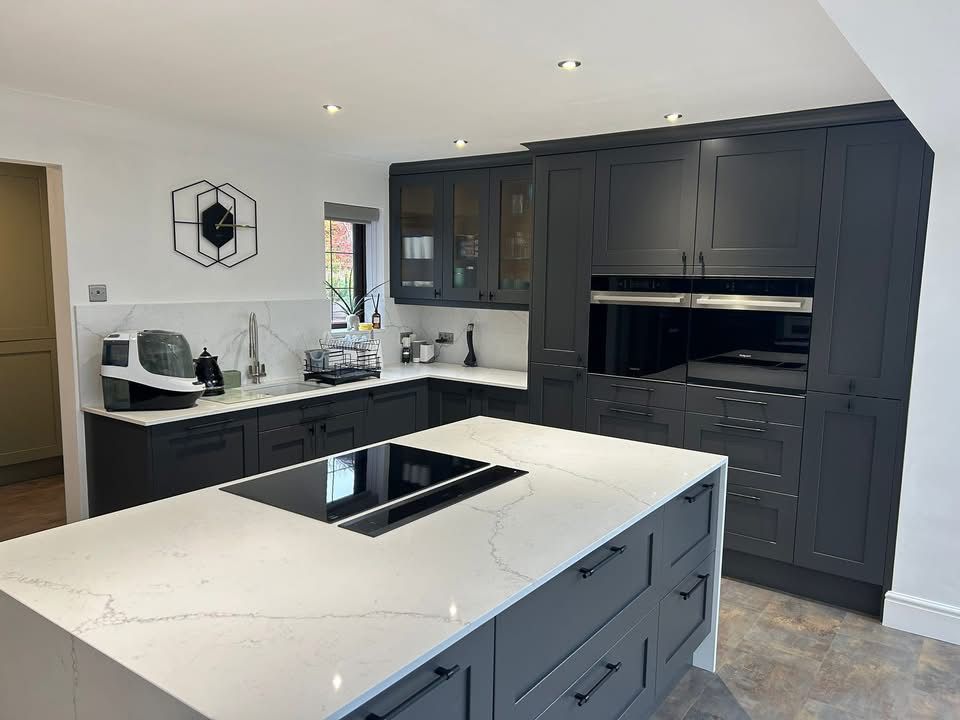 Graphite shaker kitchen with quartz island and tall integrated ovens