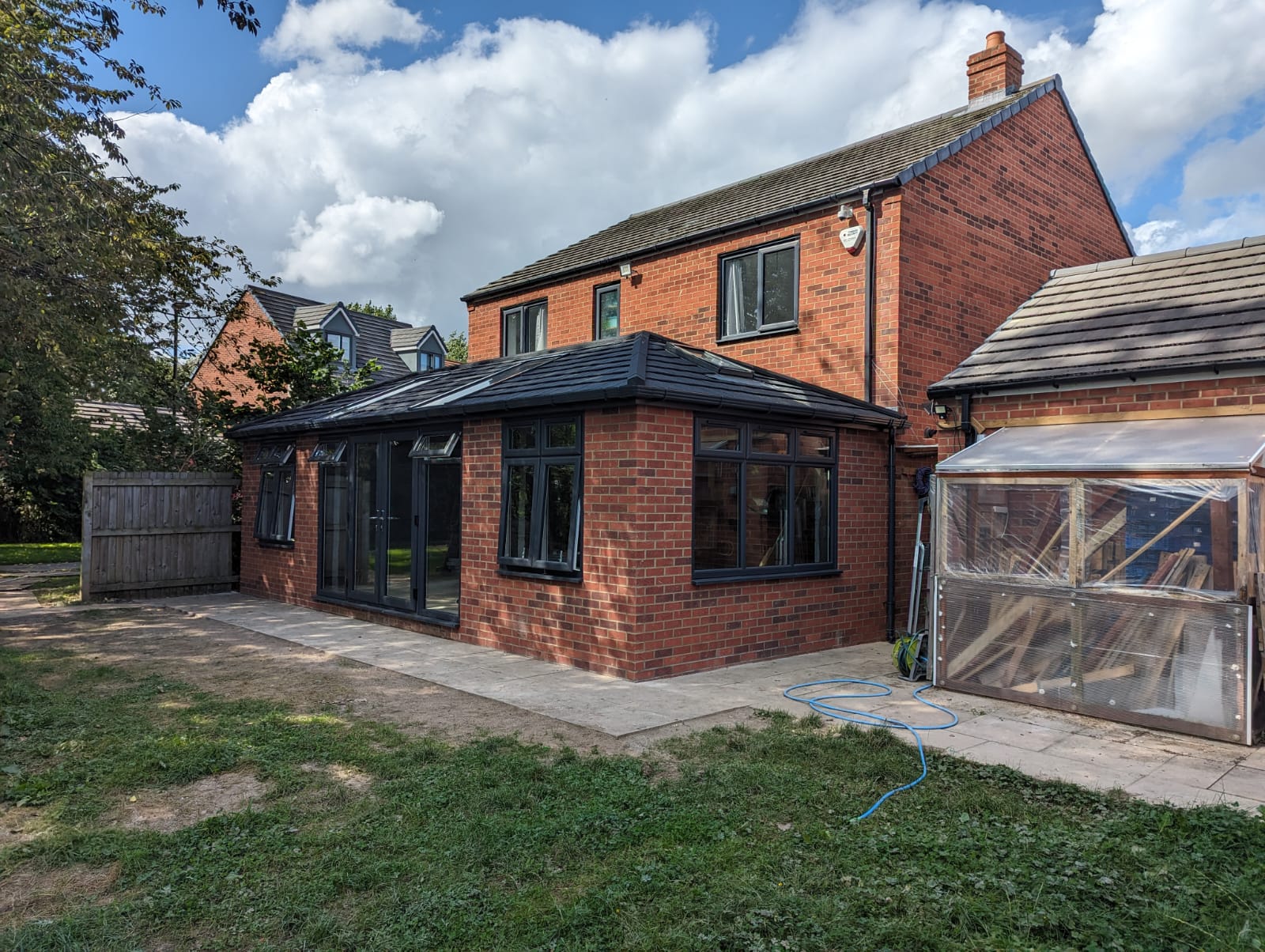 Side elevation of the brick garden room extension showing matched brickwork and anthracite grey windows