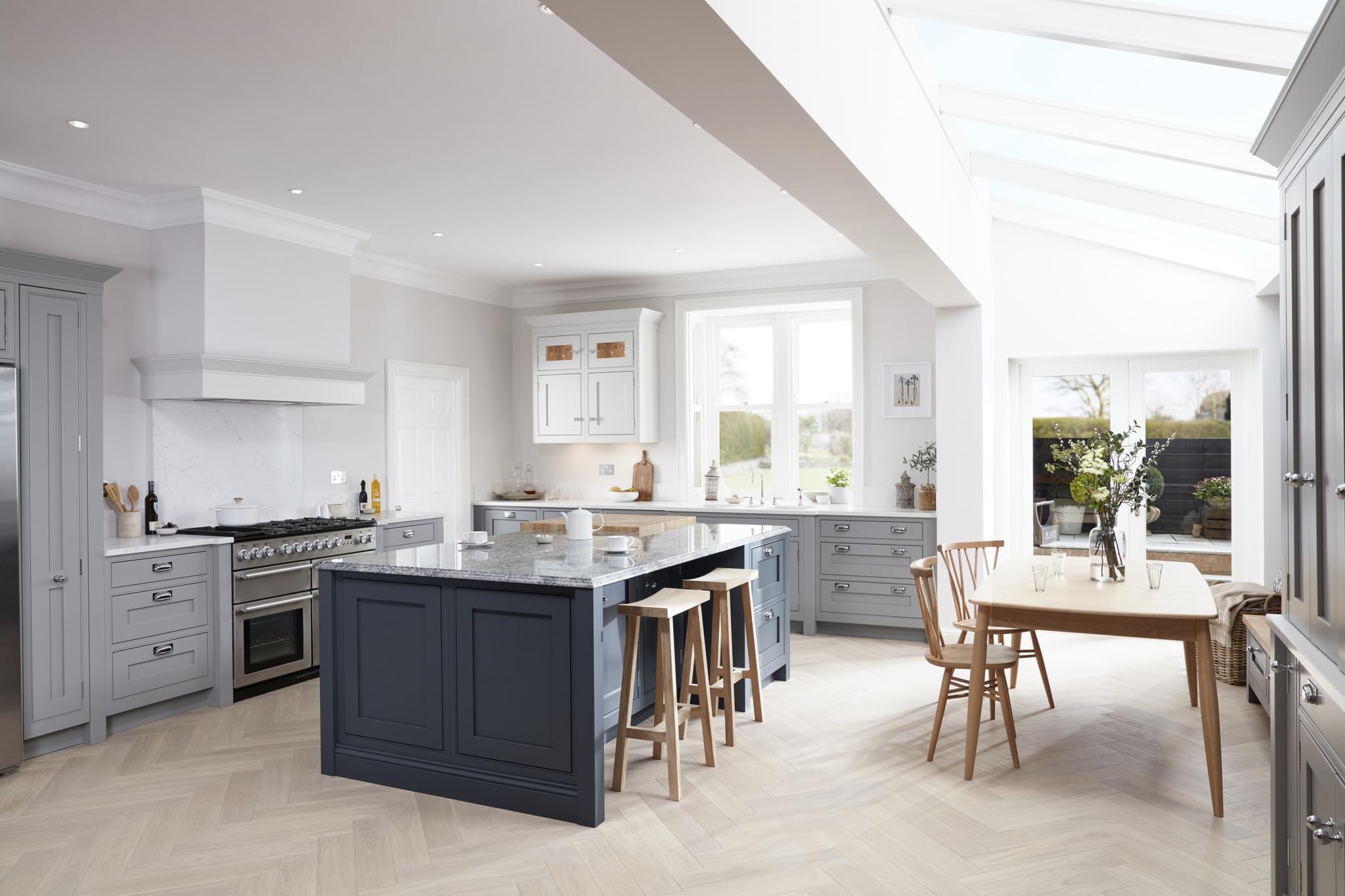 glass roof lean to kitchen extension with blue kitchen