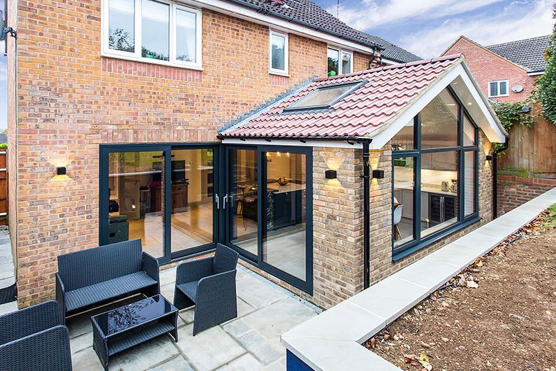 Gable front extension with sliding doors to the side